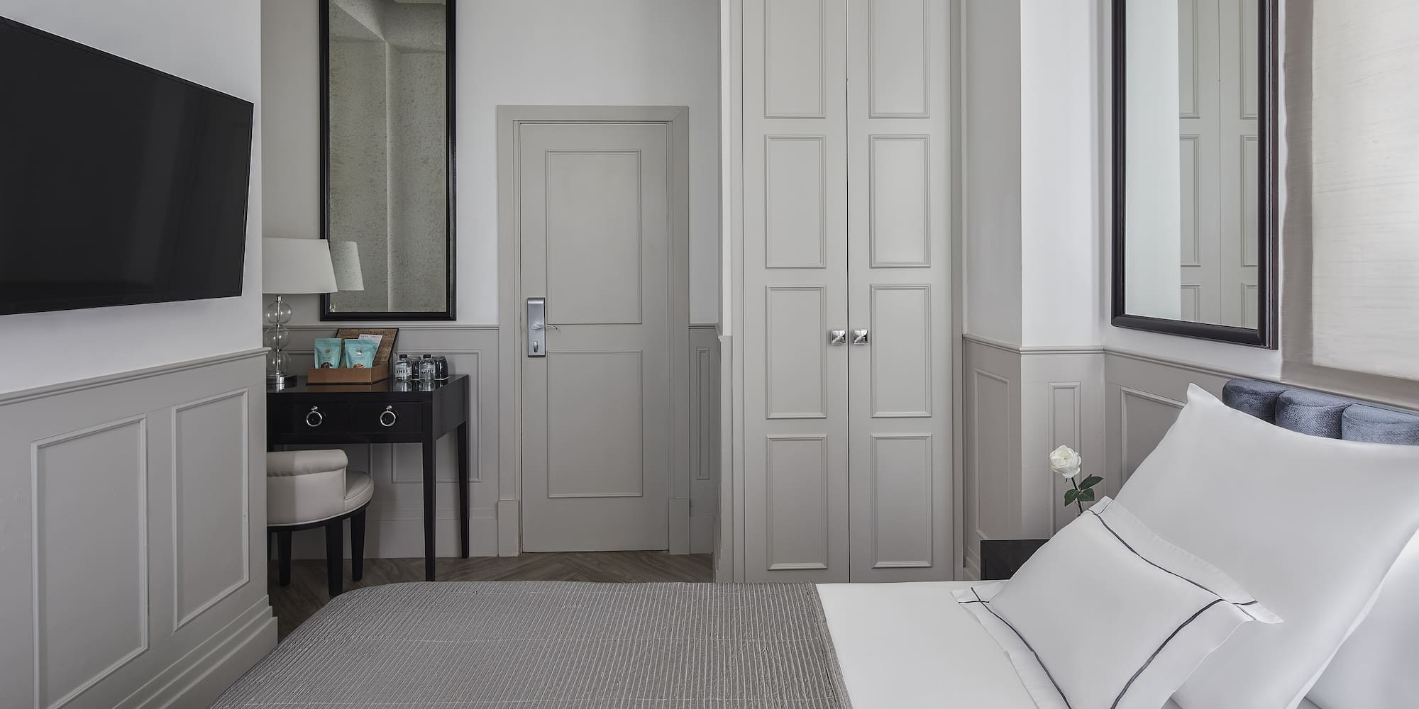 a bedroom with a bed and a mirror
