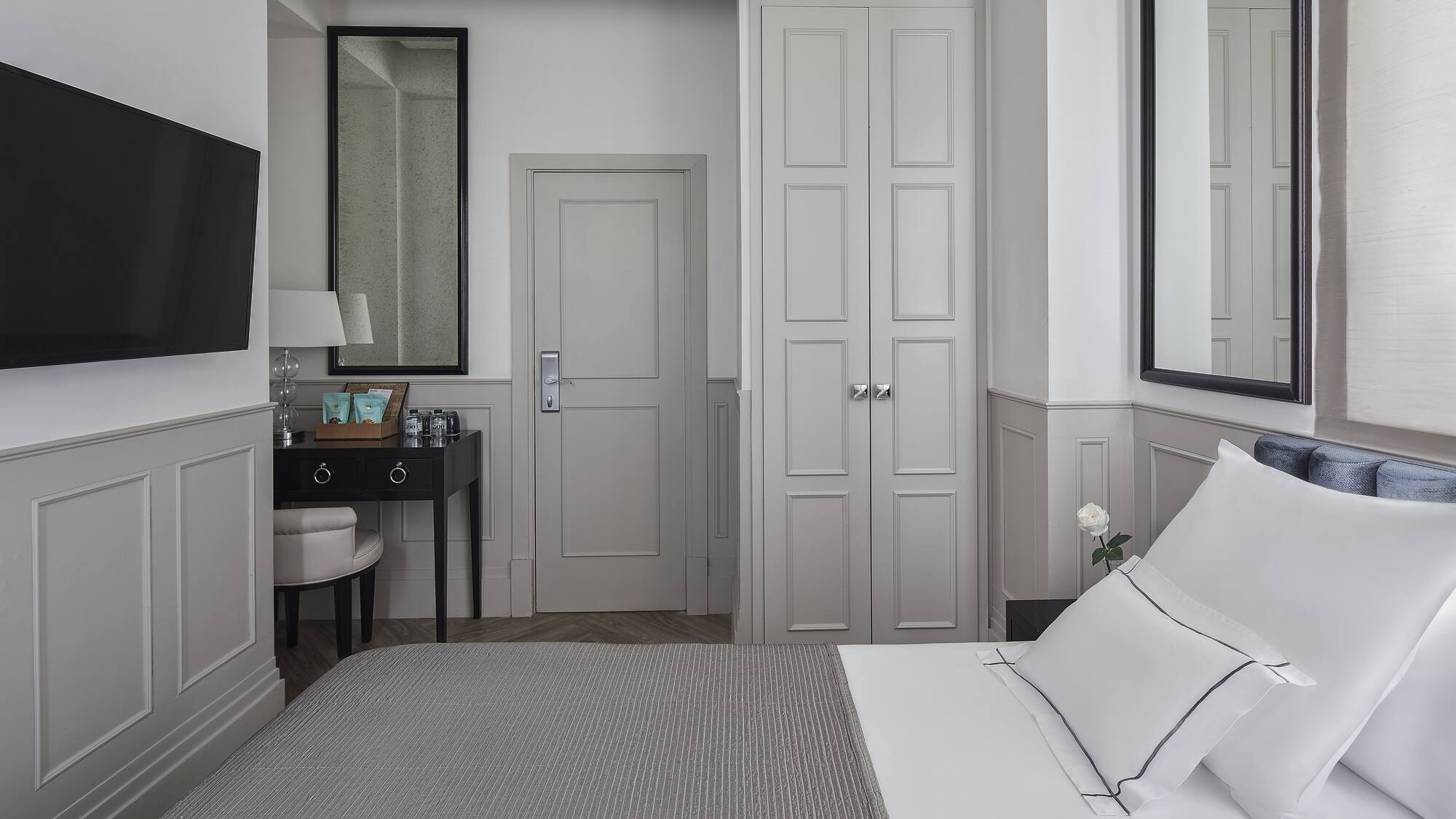 a bedroom with a bed and a mirror