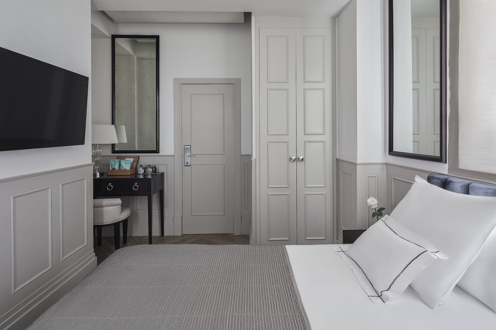 a bedroom with a bed and a mirror