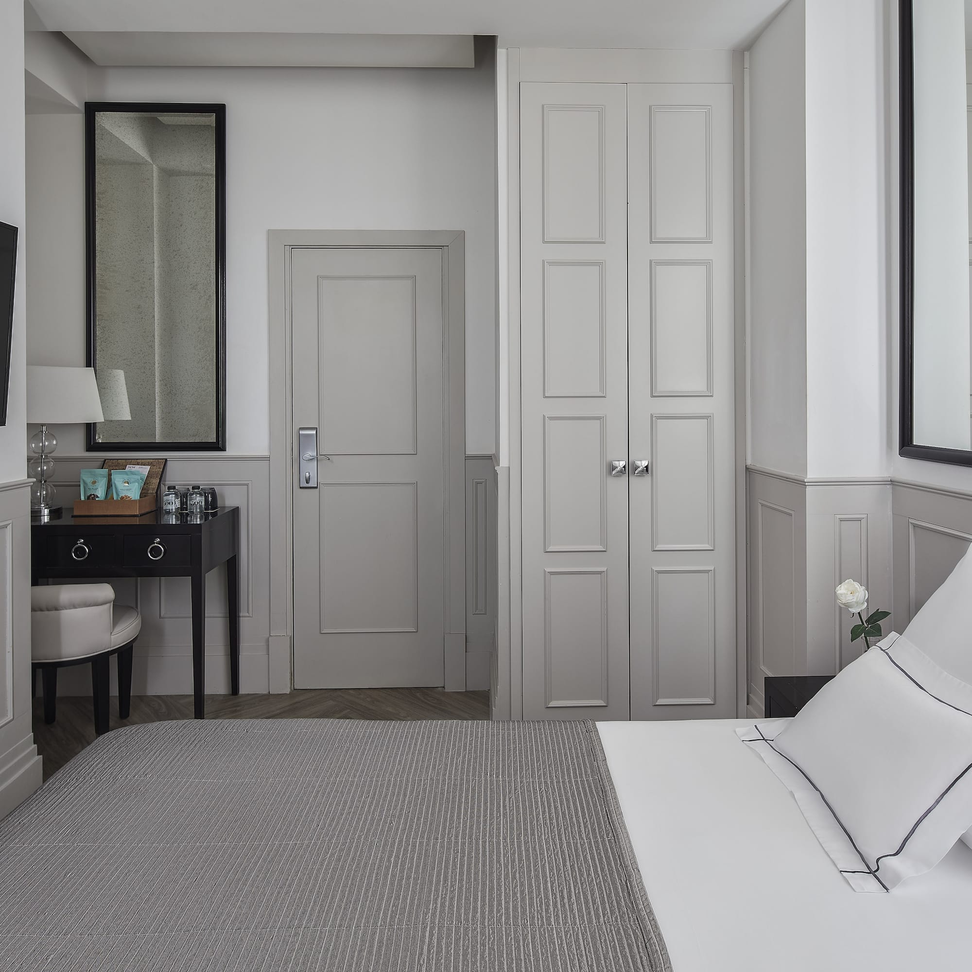 a bedroom with a bed and a mirror