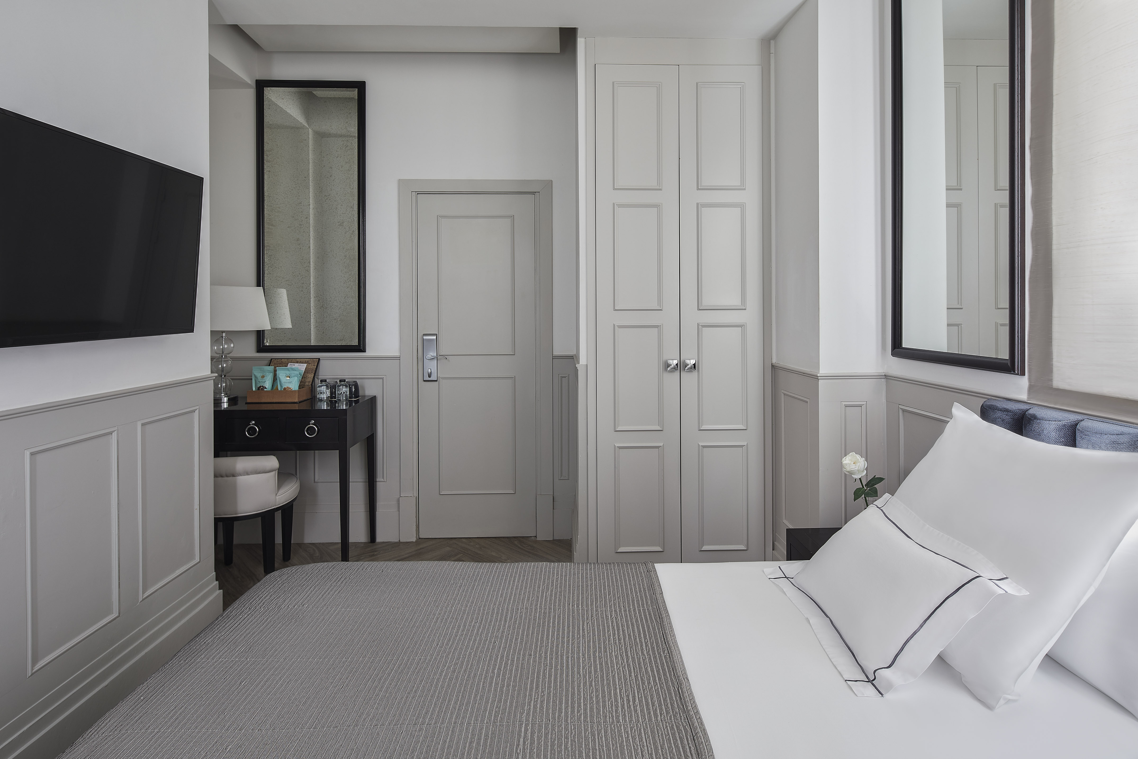 a bedroom with a bed and a mirror