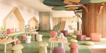 a room with a playroom with a tree and tables and chairs