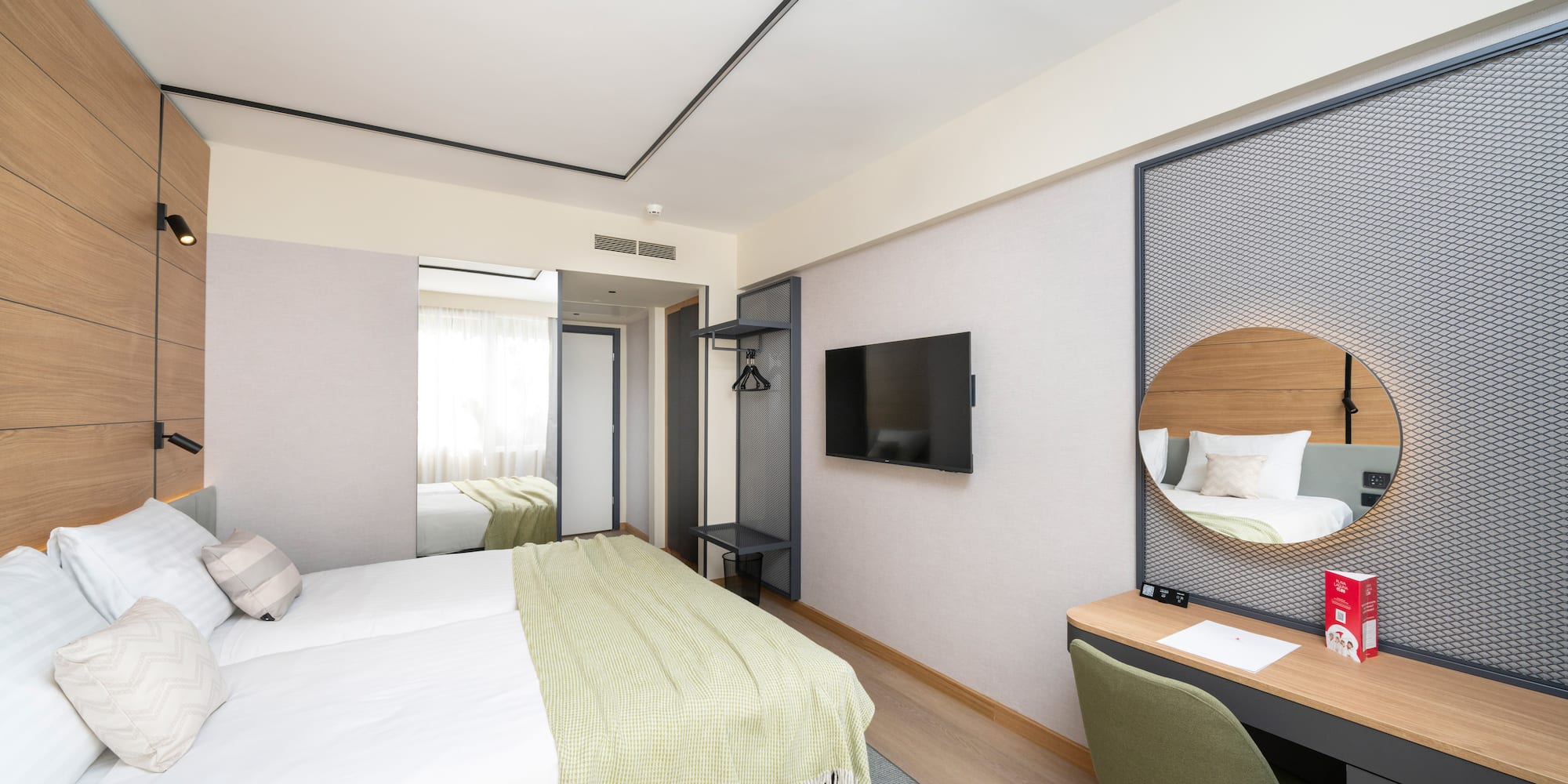 a room with a bed and a mirror