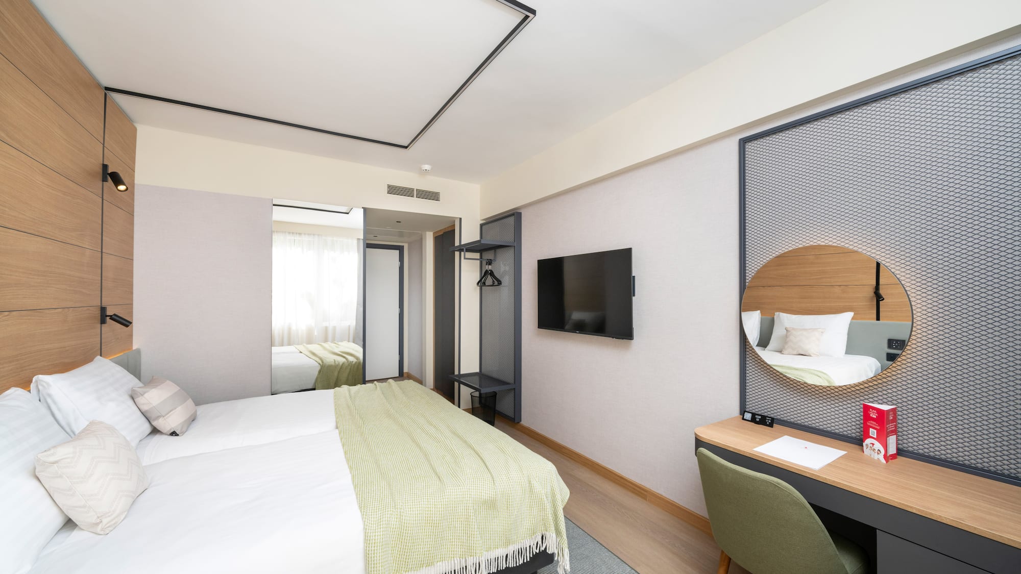 a room with a bed and a mirror