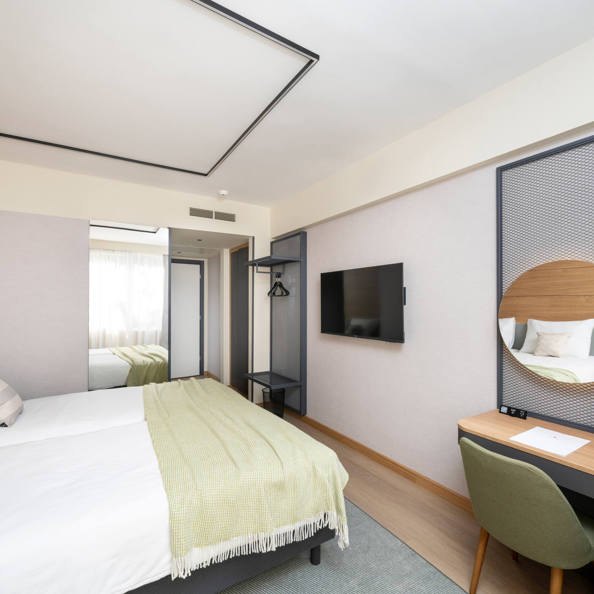 a room with a bed and a mirror