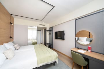 a room with a bed and a mirror