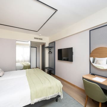 a room with a bed and a mirror