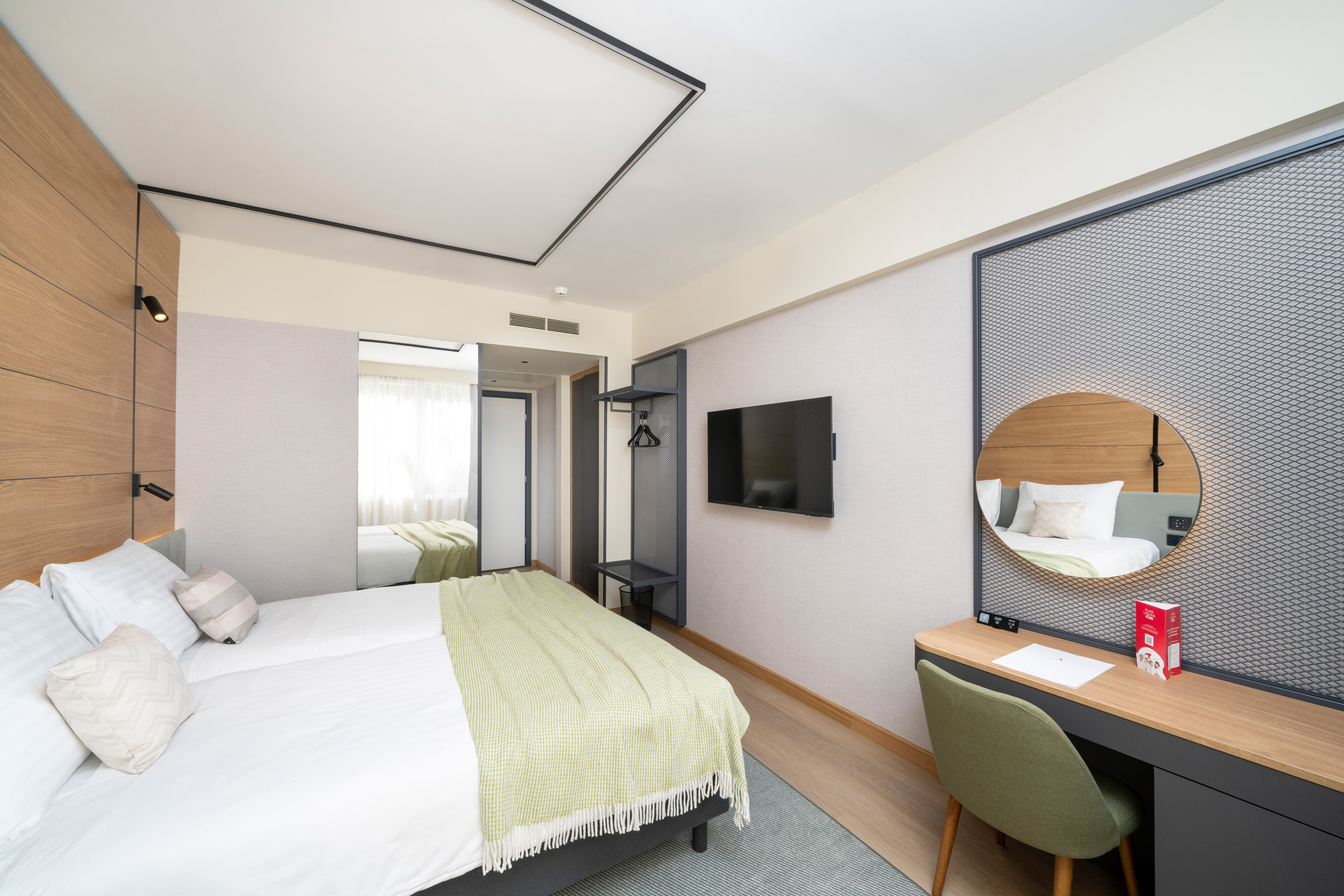 a room with a bed and a mirror