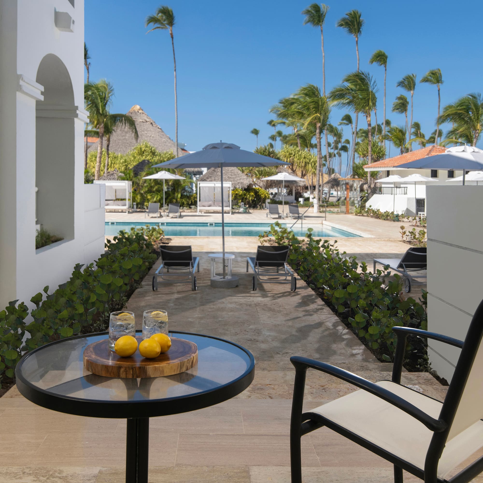 a table with two lemons on it and a pool in the background