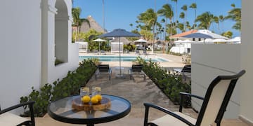 a table with two lemons on it and a pool in the background