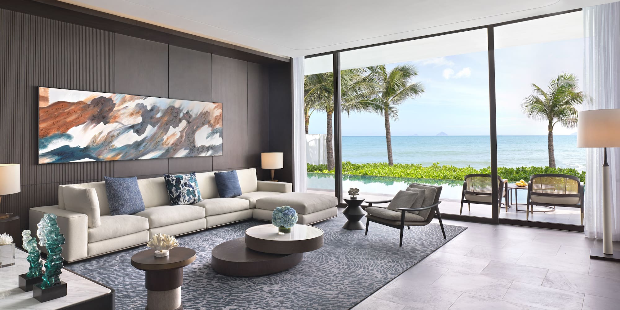 a living room with a large window overlooking the ocean