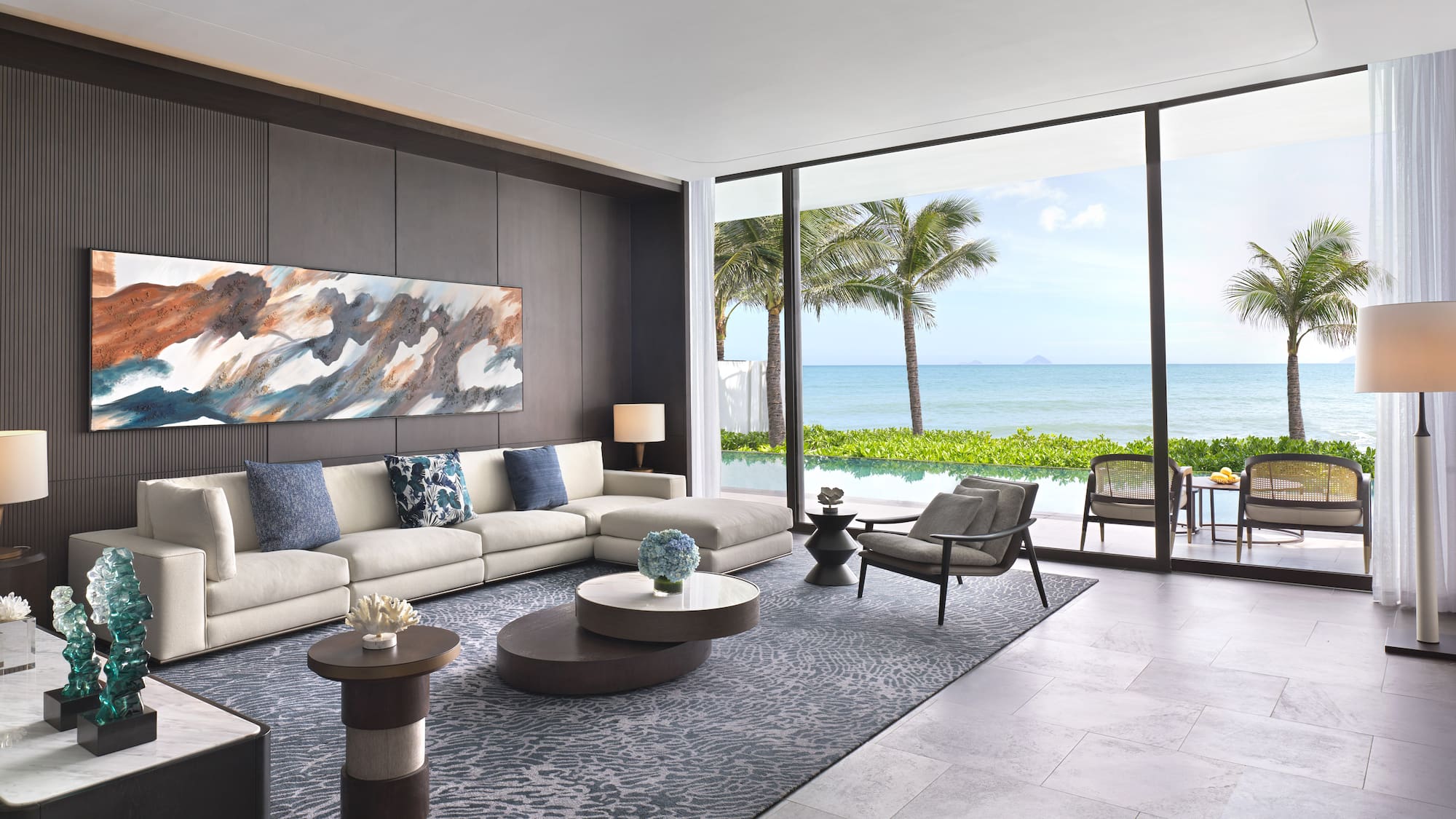 a living room with a large window overlooking the ocean