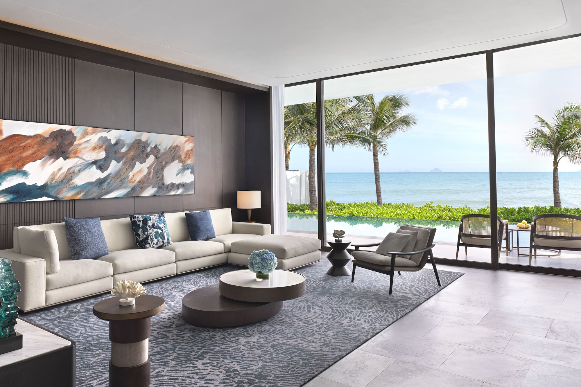 a living room with a large window overlooking the ocean