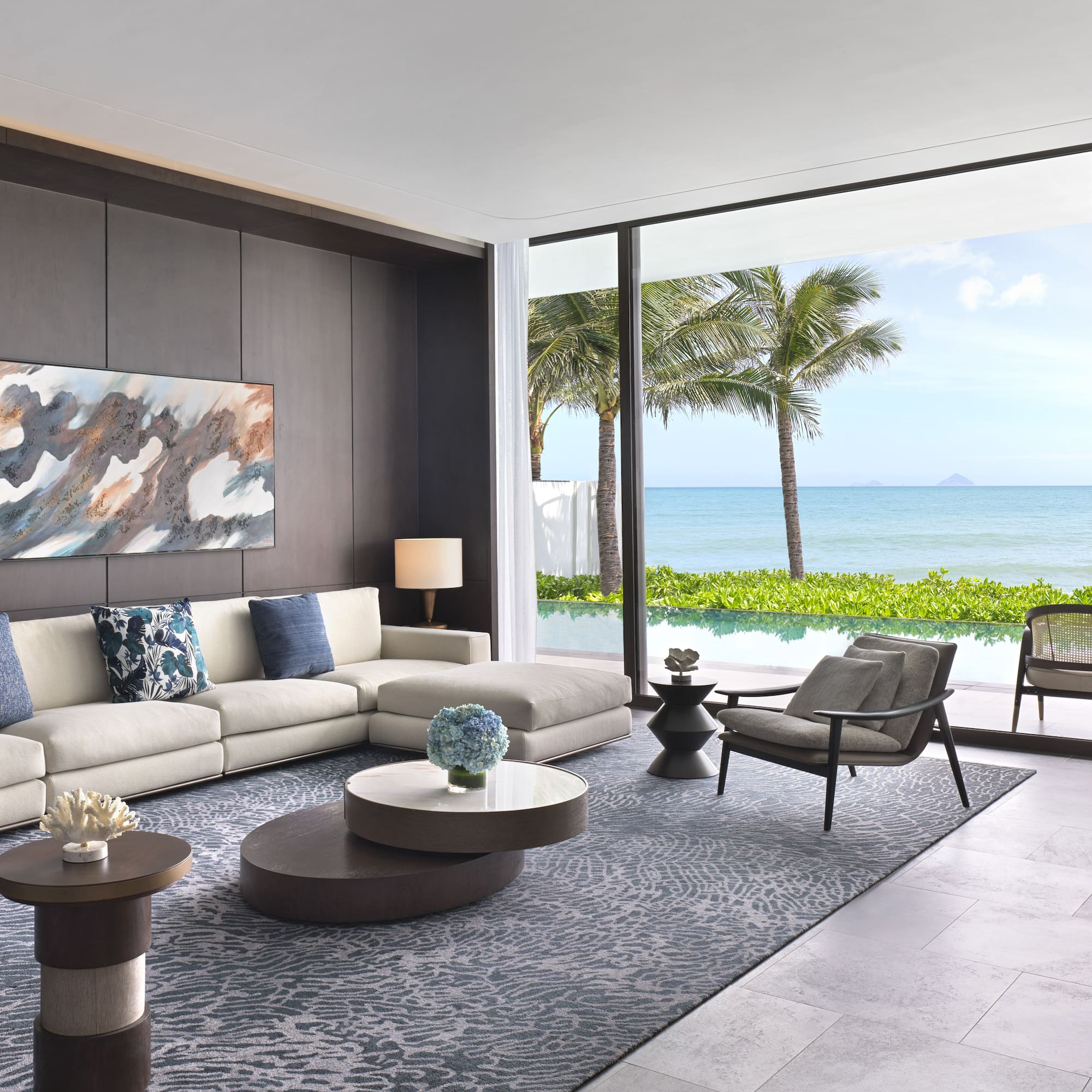 a living room with a large window overlooking the ocean