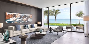 a living room with a large window overlooking the ocean