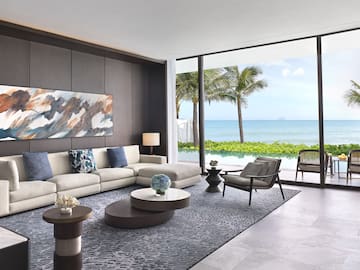 a living room with a large window overlooking the ocean