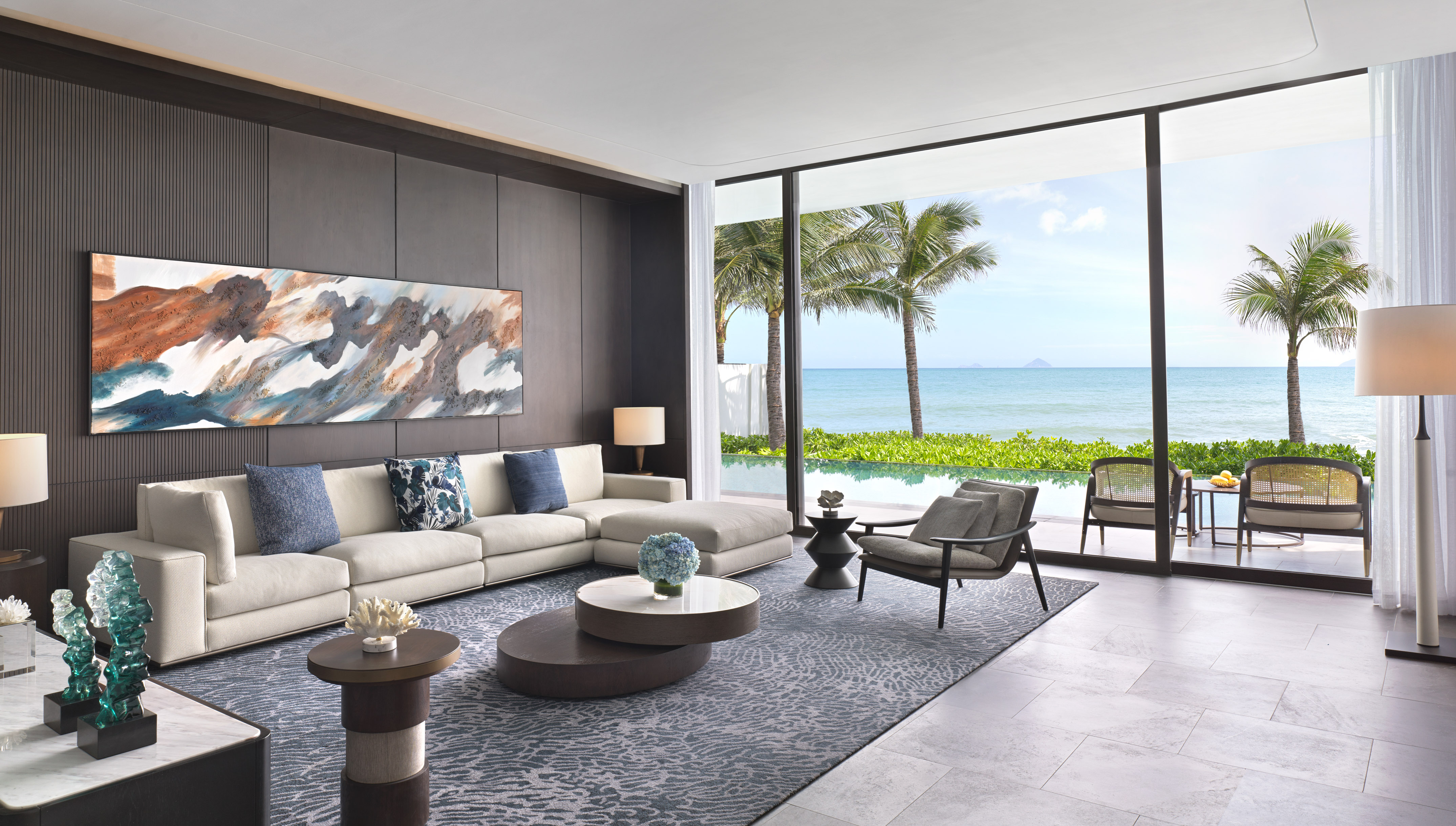 a living room with a large window overlooking the ocean