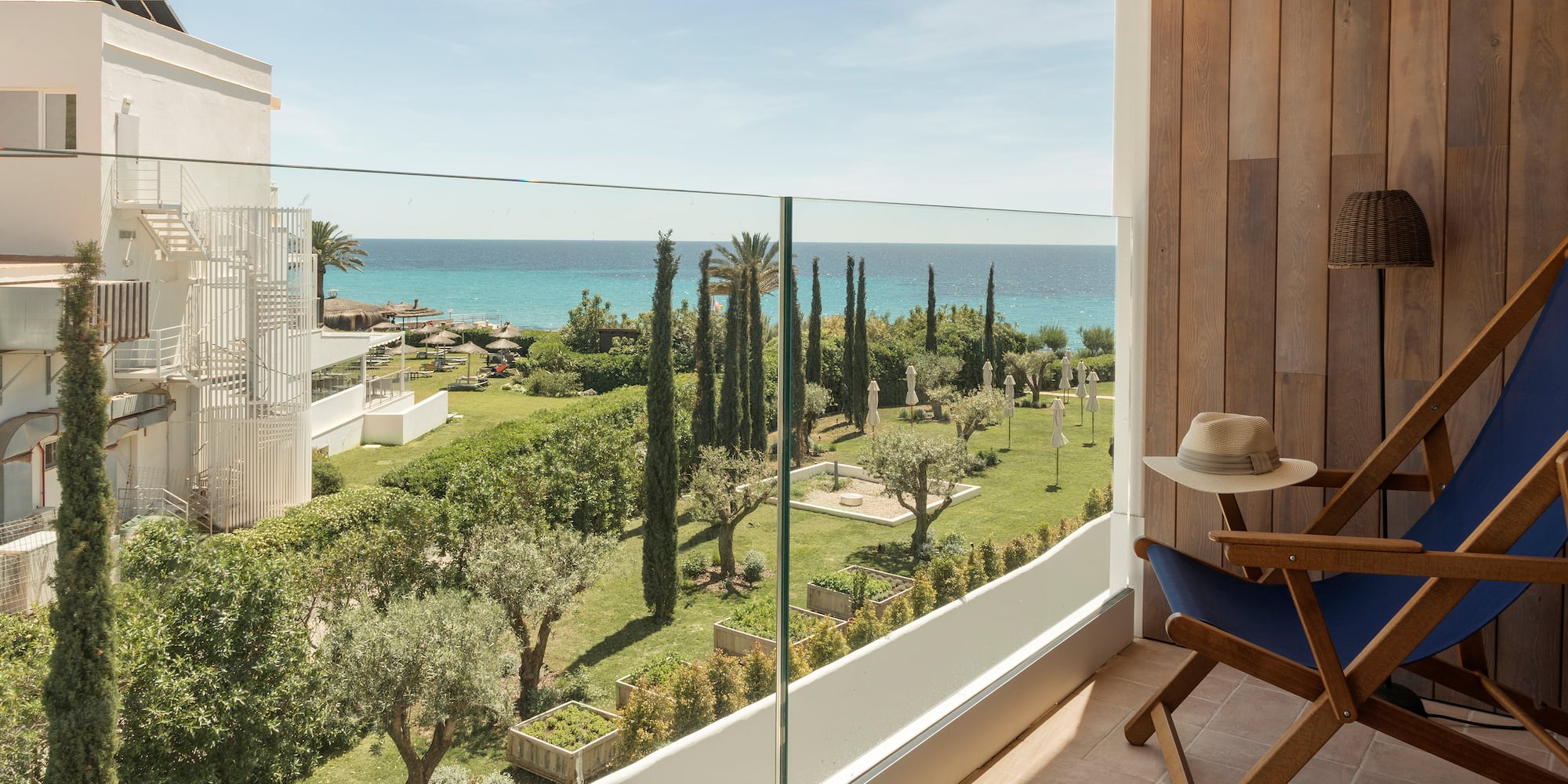 a balcony with a view of the ocean and trees