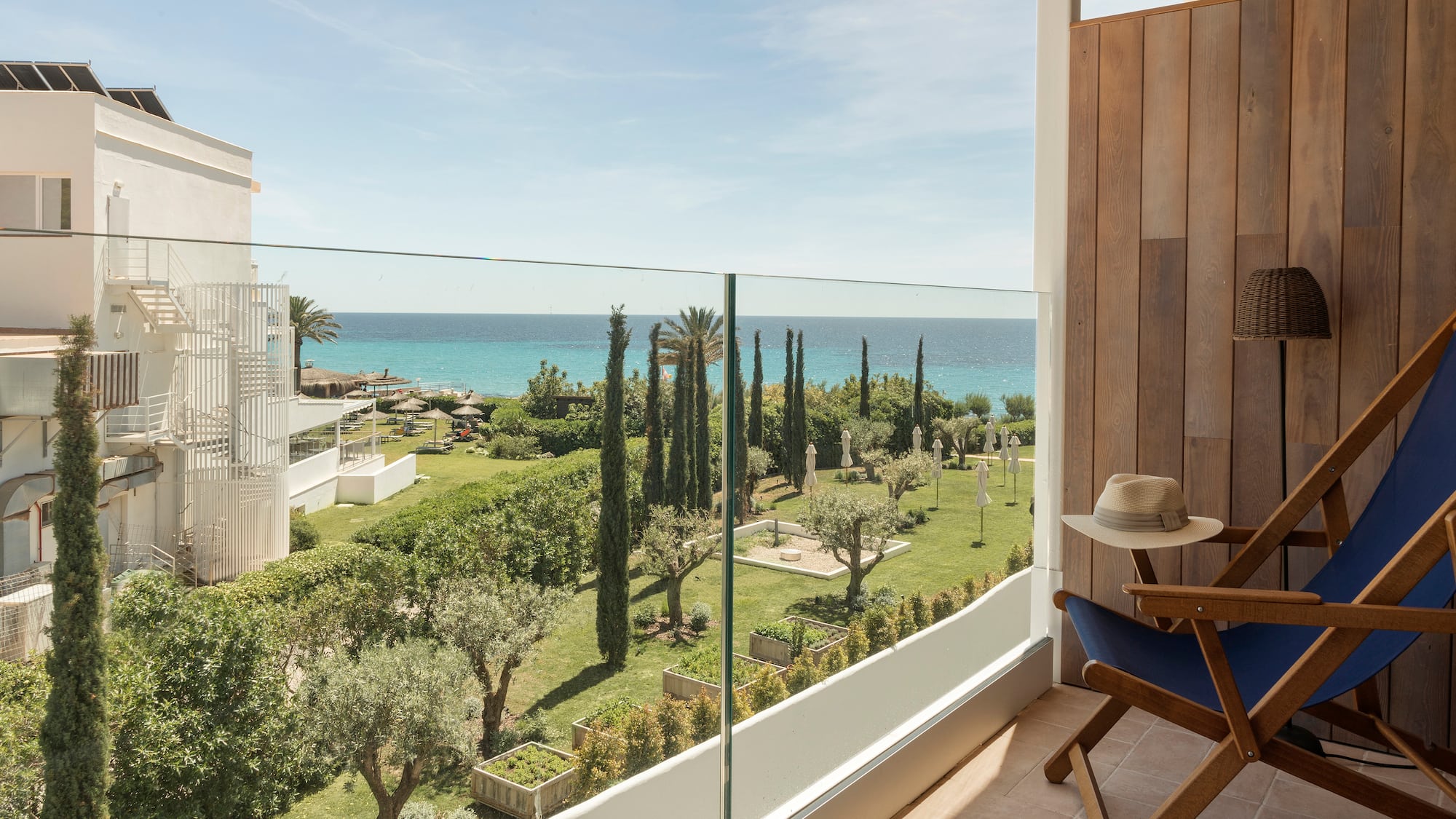 a balcony with a view of the ocean and trees