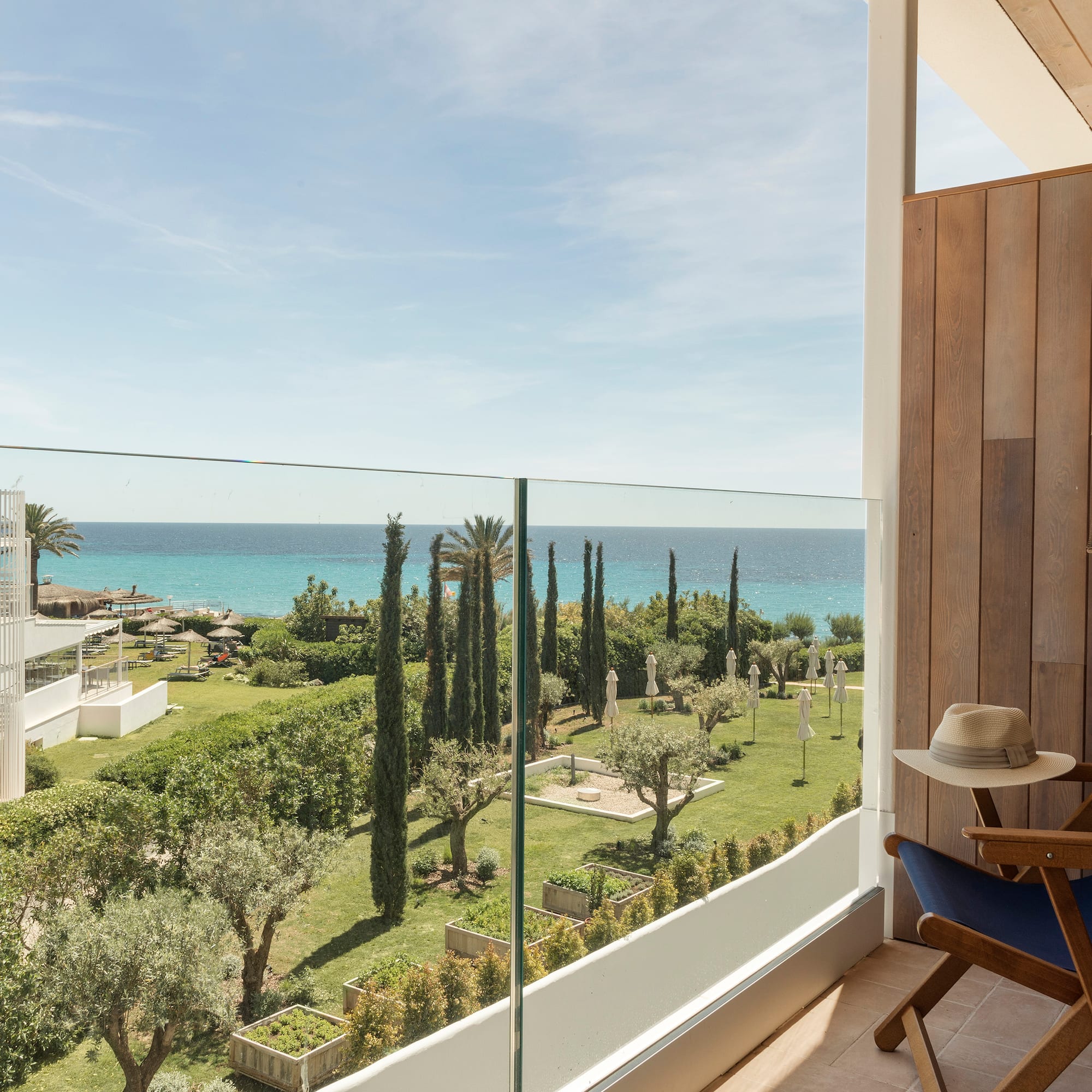 a balcony with a view of the ocean and trees