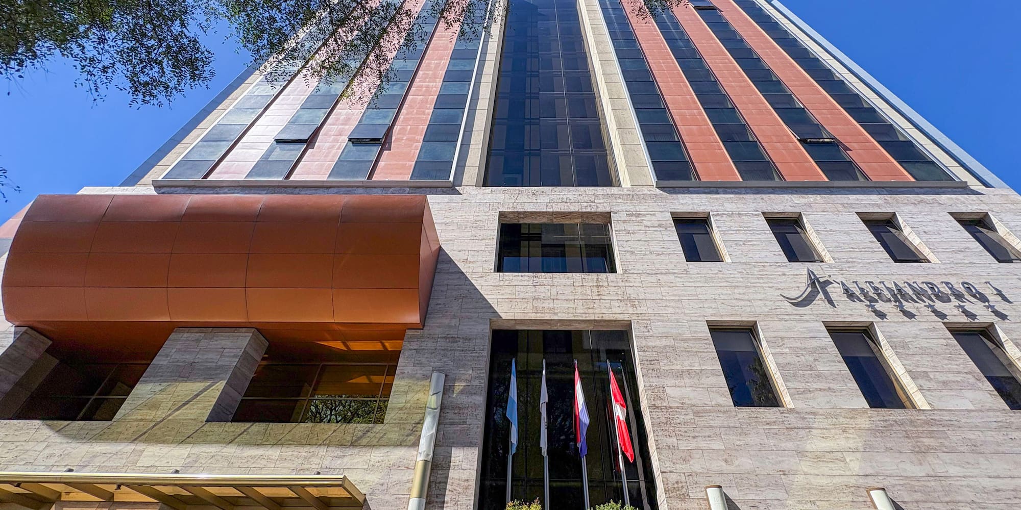 a building with trees and a blue sky