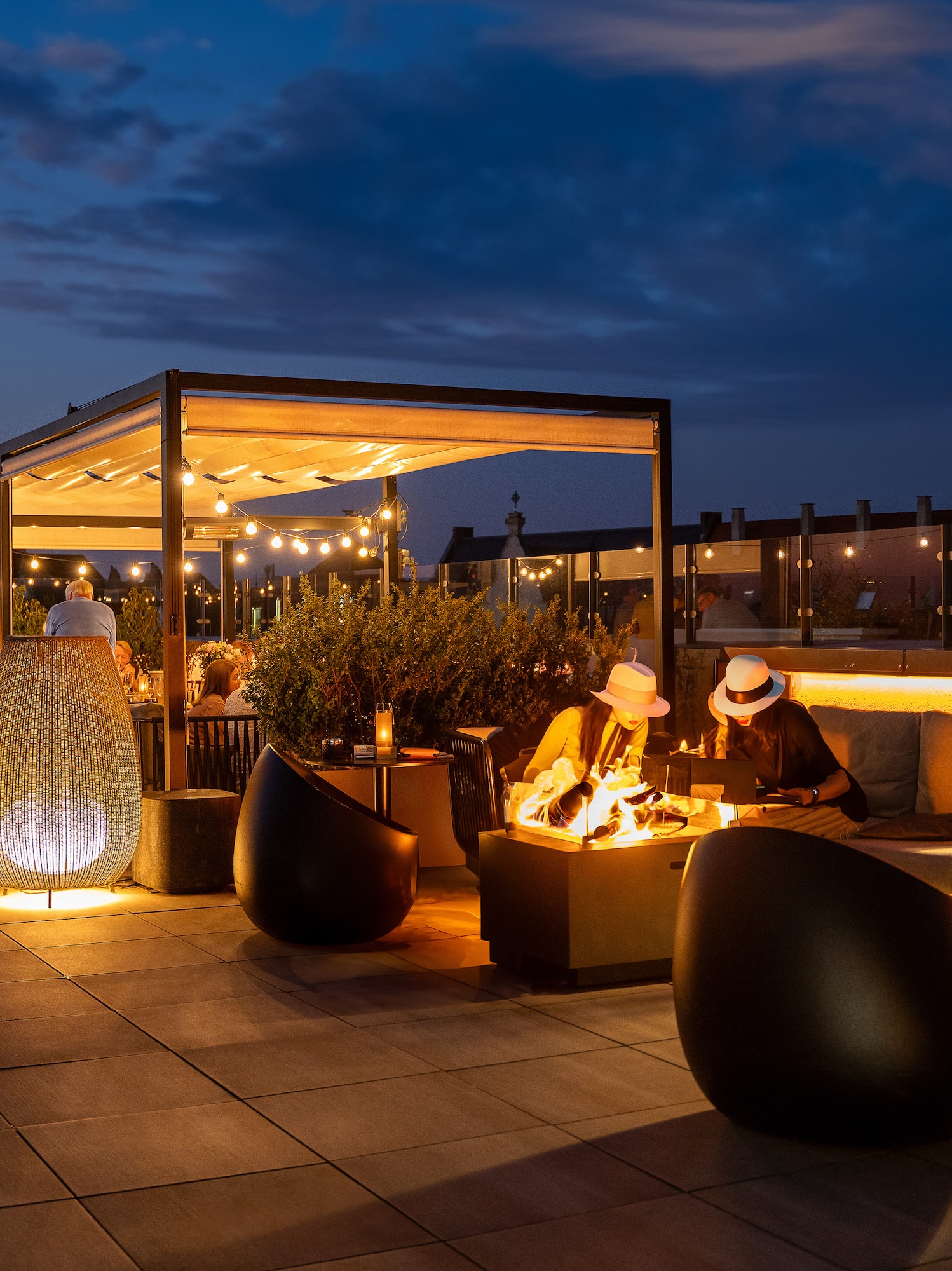 people sitting at a table on a rooftop