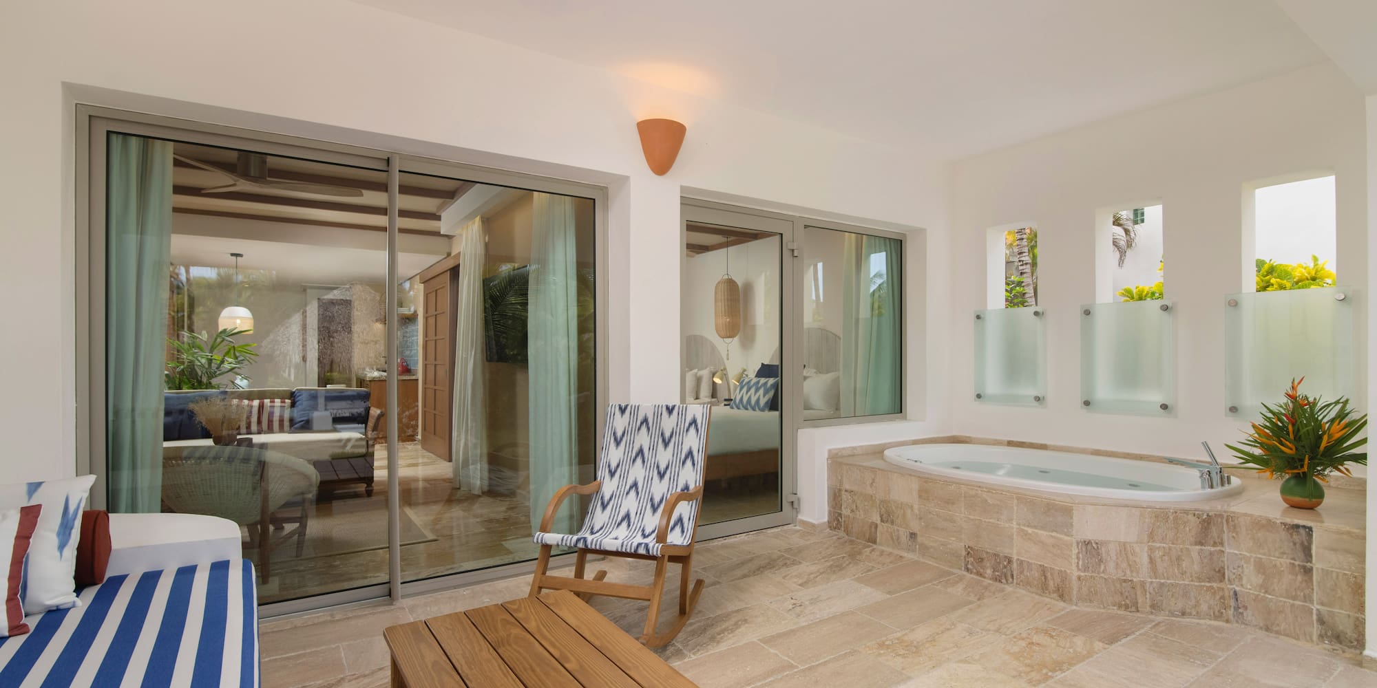 a room with a jacuzzi and a chair