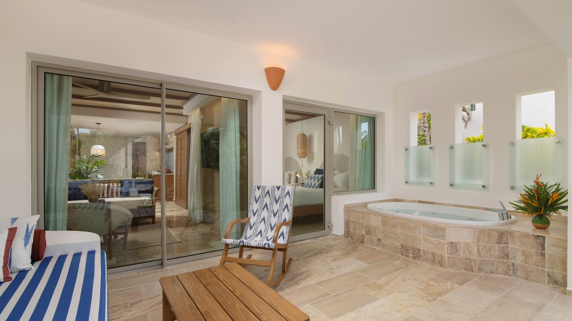 a room with a jacuzzi and a chair