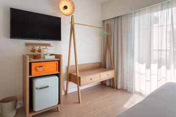 a room with a tv and a shelf