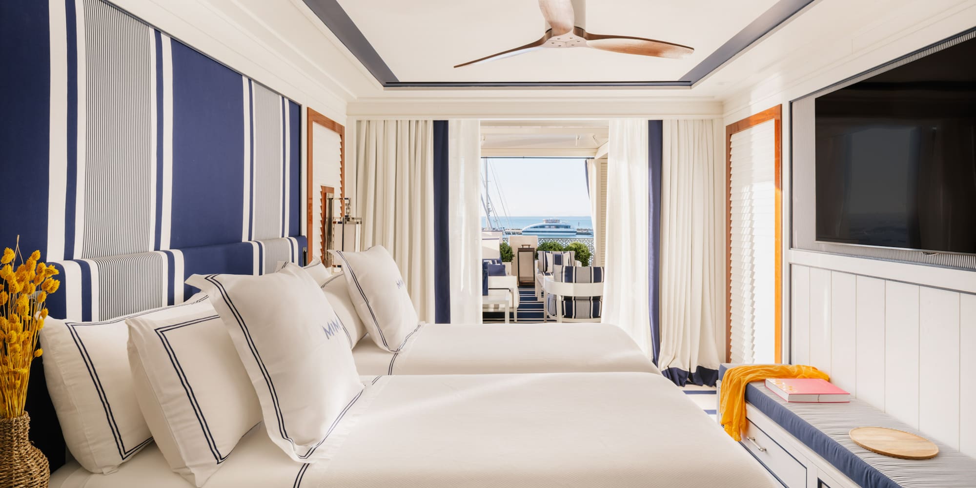 a room with two beds and a television