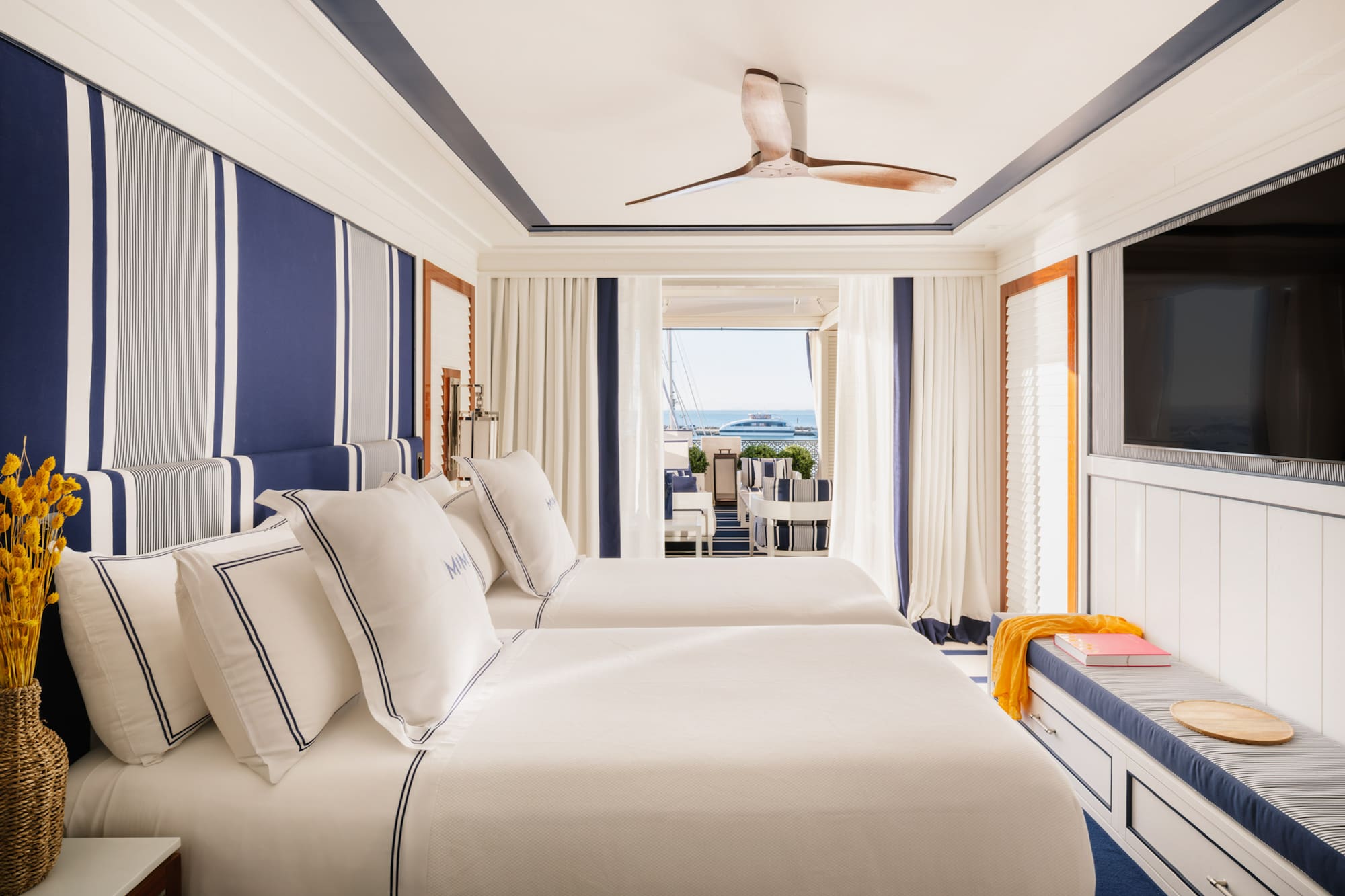 a room with two beds and a television