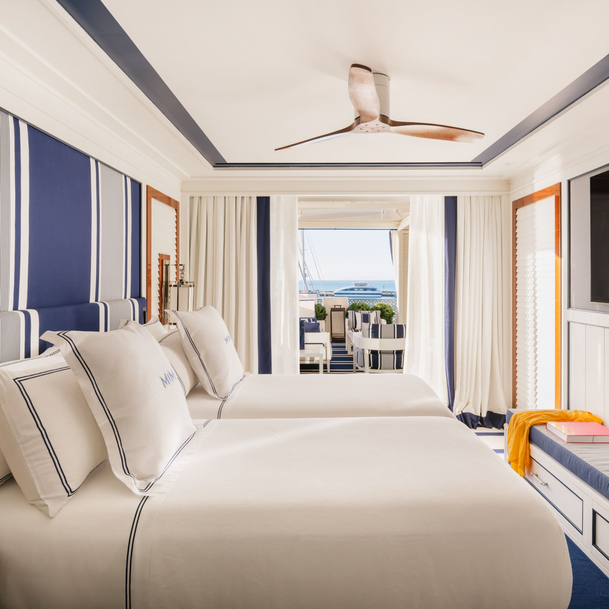 a room with two beds and a television