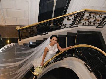 a woman in a wedding dress on a staircase