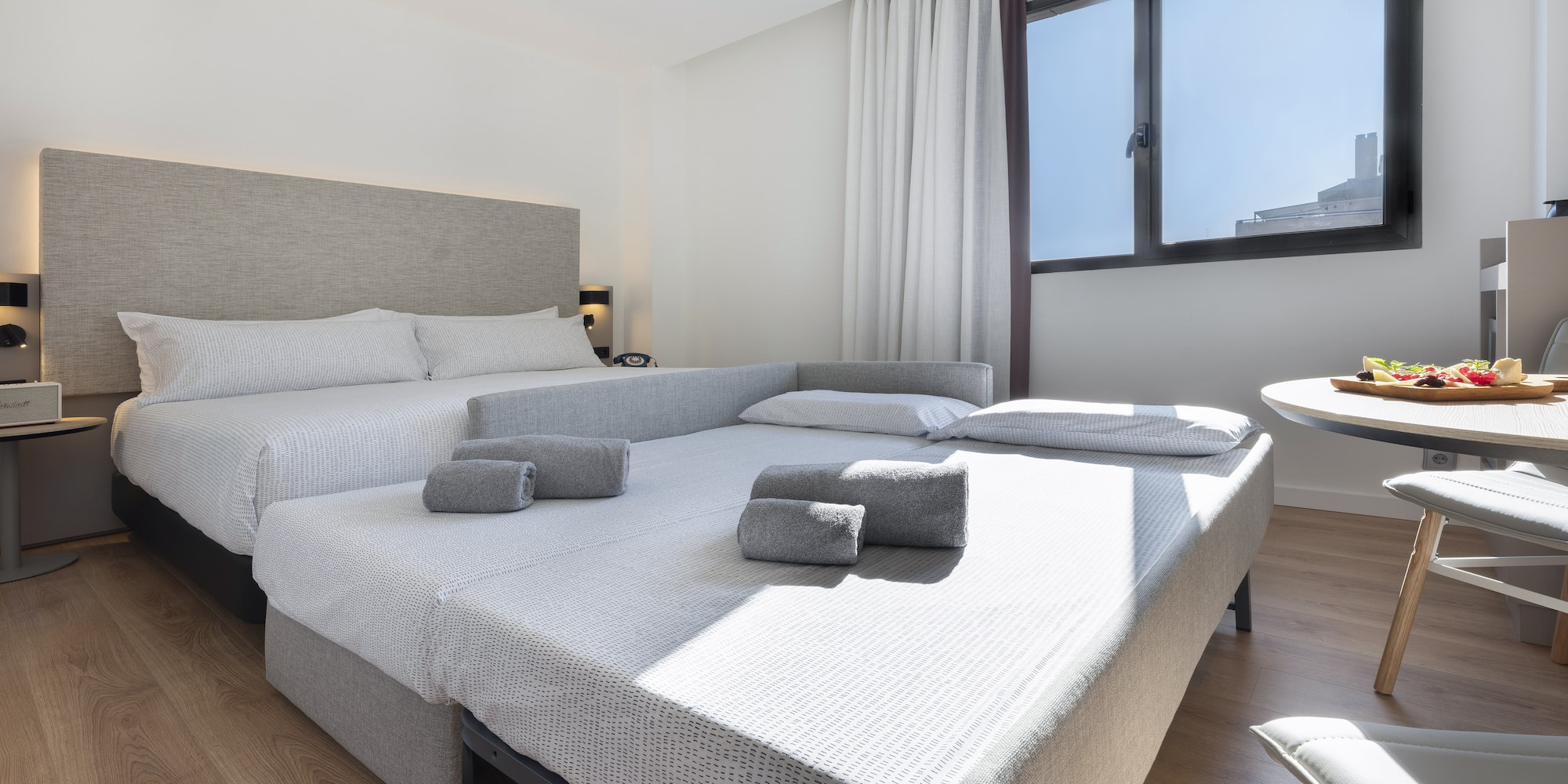 a room with two beds and a table