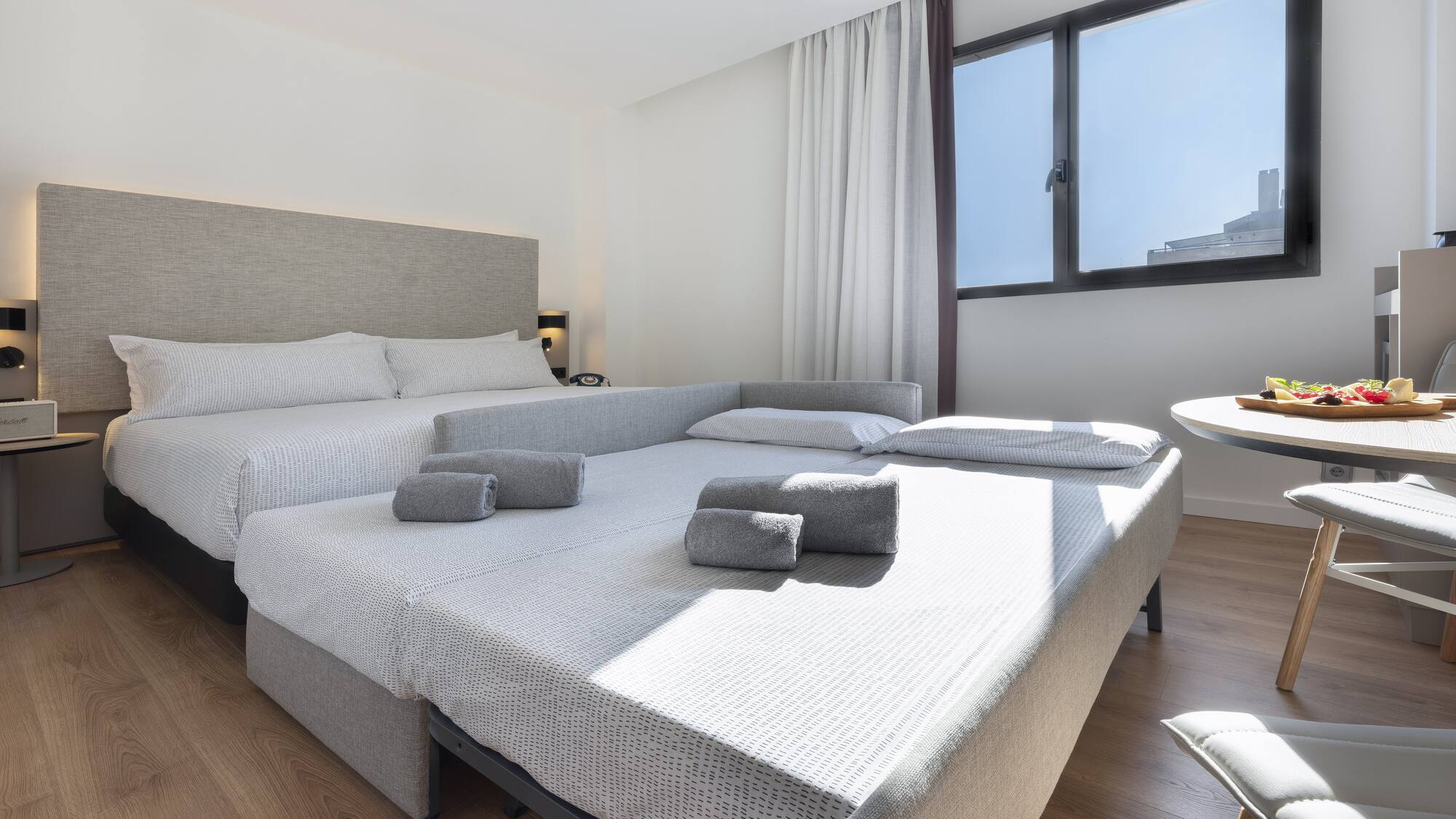 a room with two beds and a table