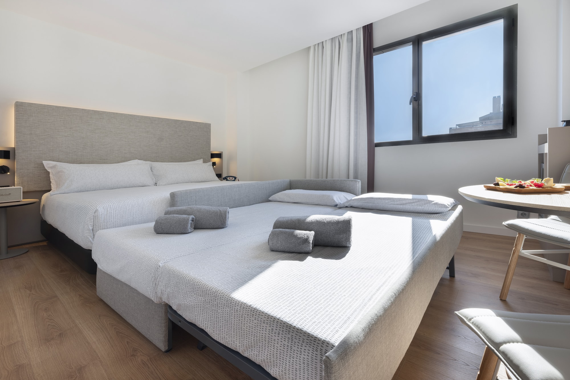 a room with two beds and a table