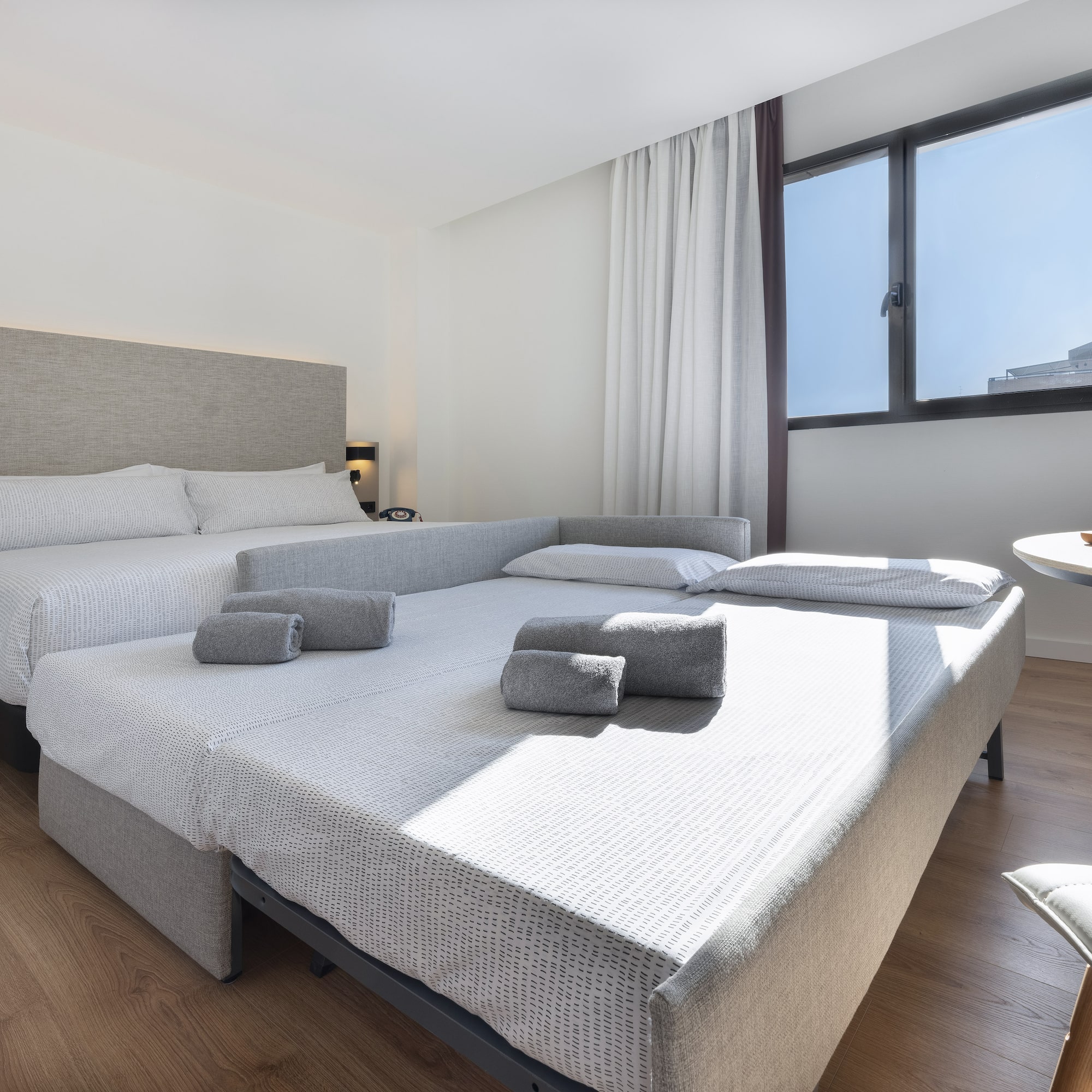 a room with two beds and a table