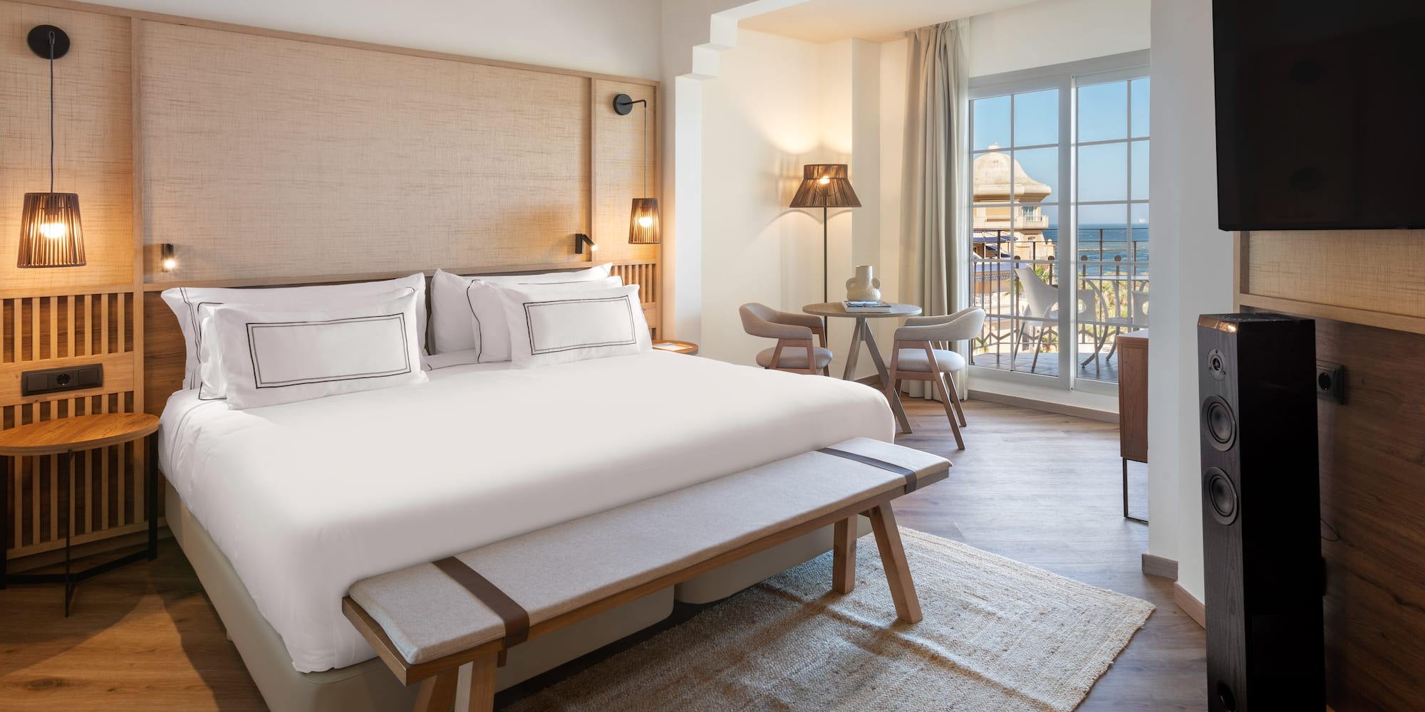 a room with a bed and a table and chairs