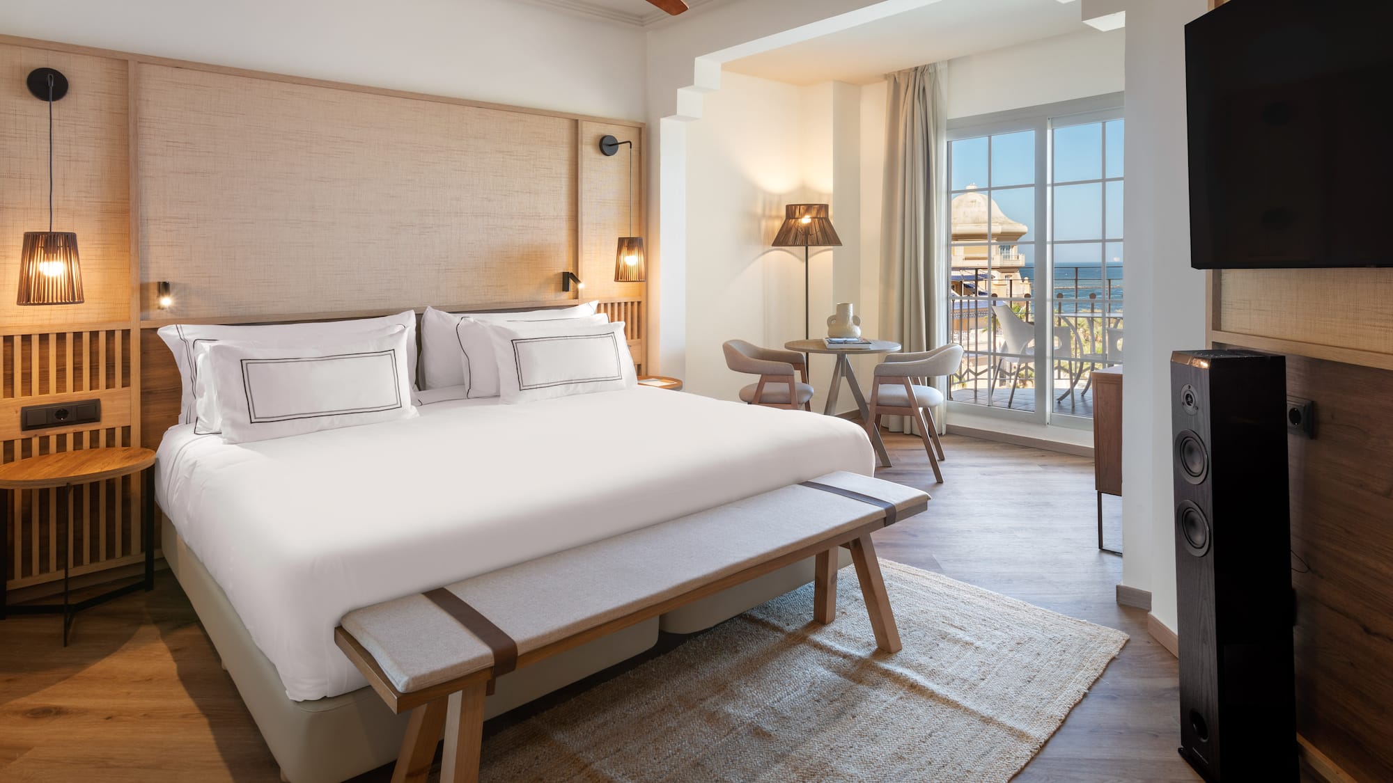 a room with a bed and a table and chairs