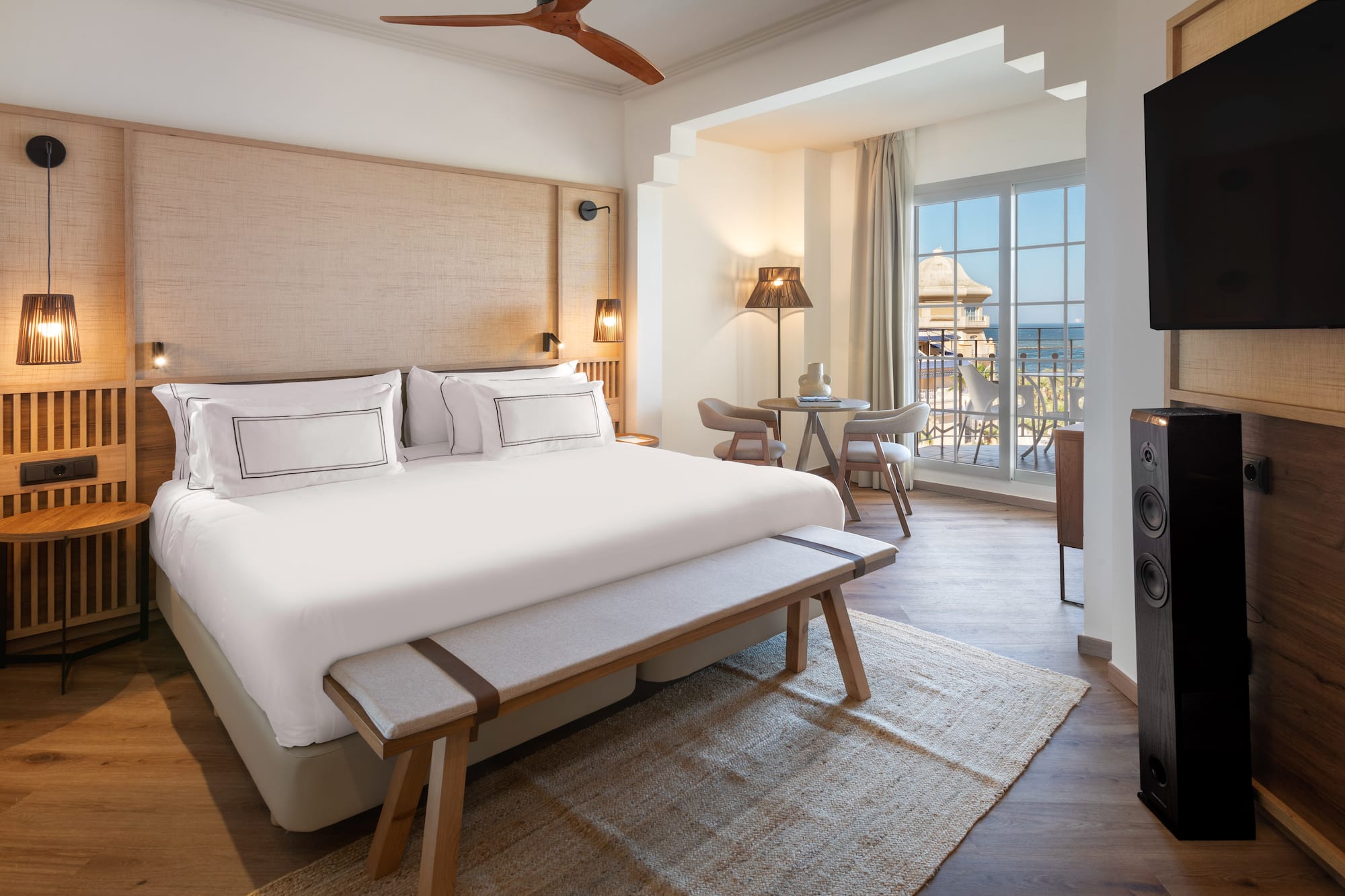 a room with a bed and a table and chairs