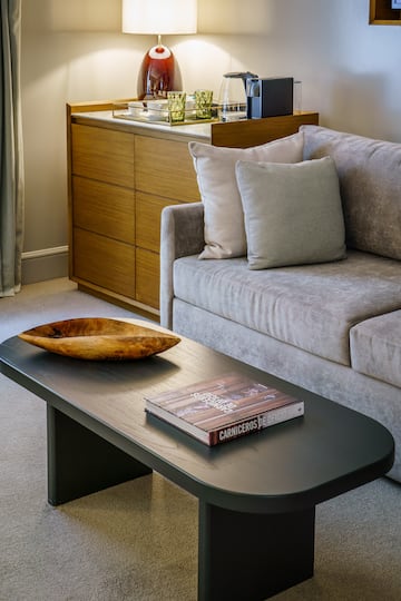 a couch with a wood bowl on top of a coffee table