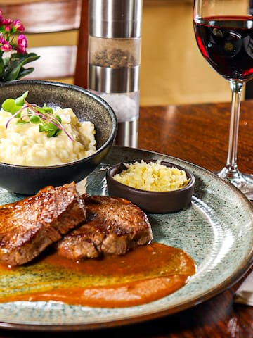 a plate of food and a glass of wine