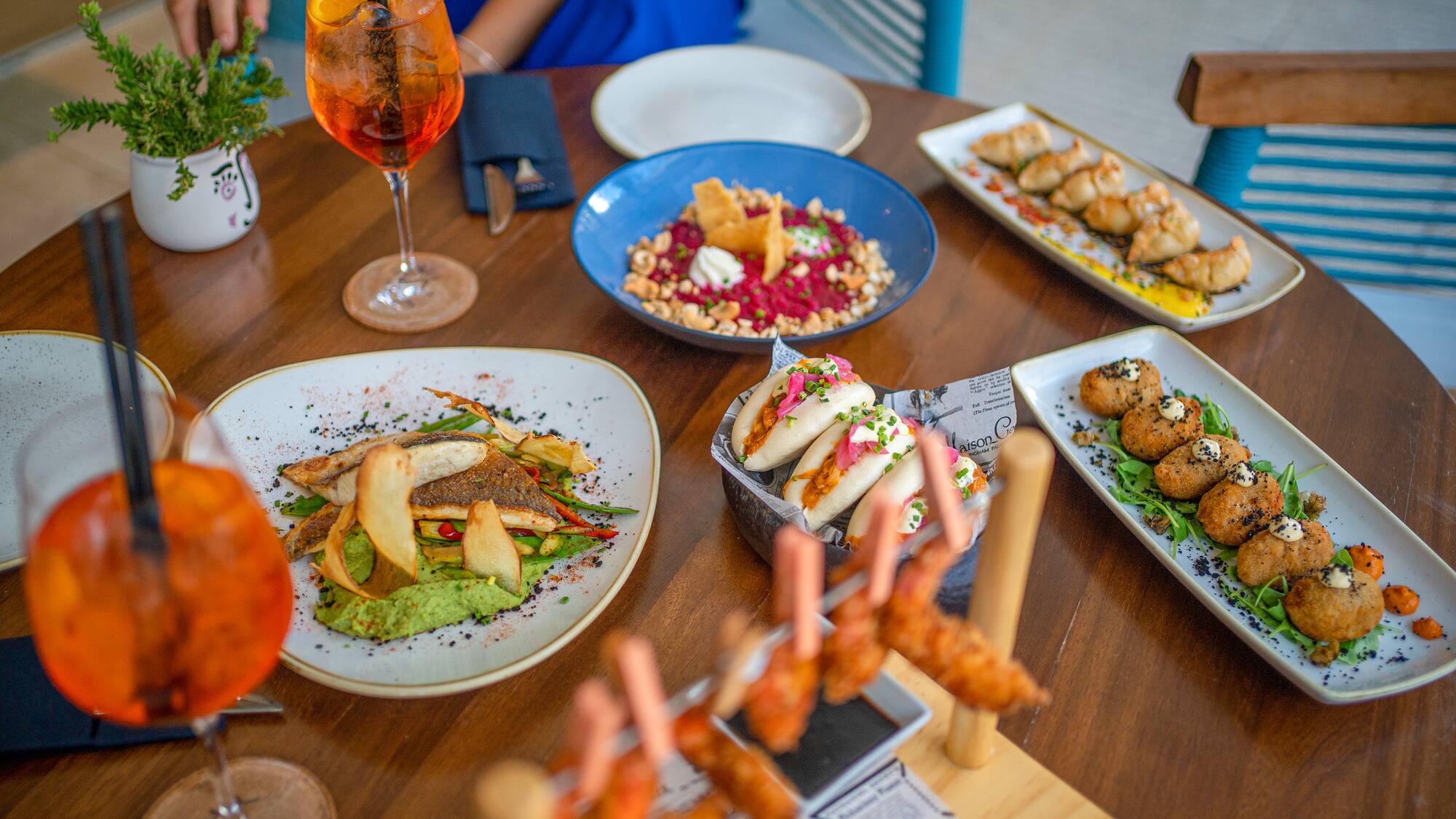 a table with plates of food and drinks