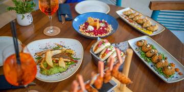 a table with plates of food and drinks
