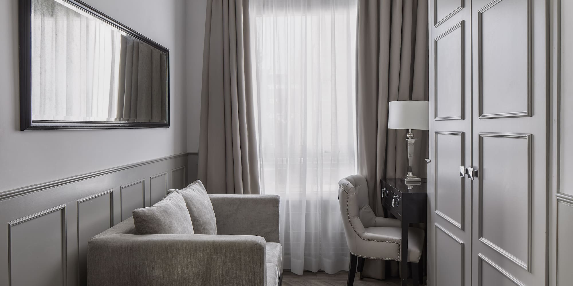 a room with a couch and a mirror