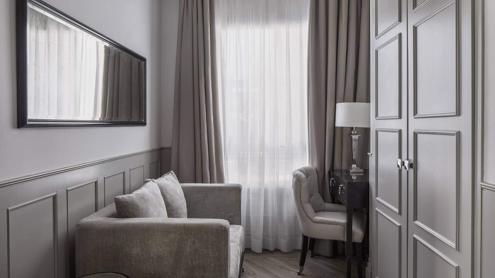 a room with a couch and a mirror