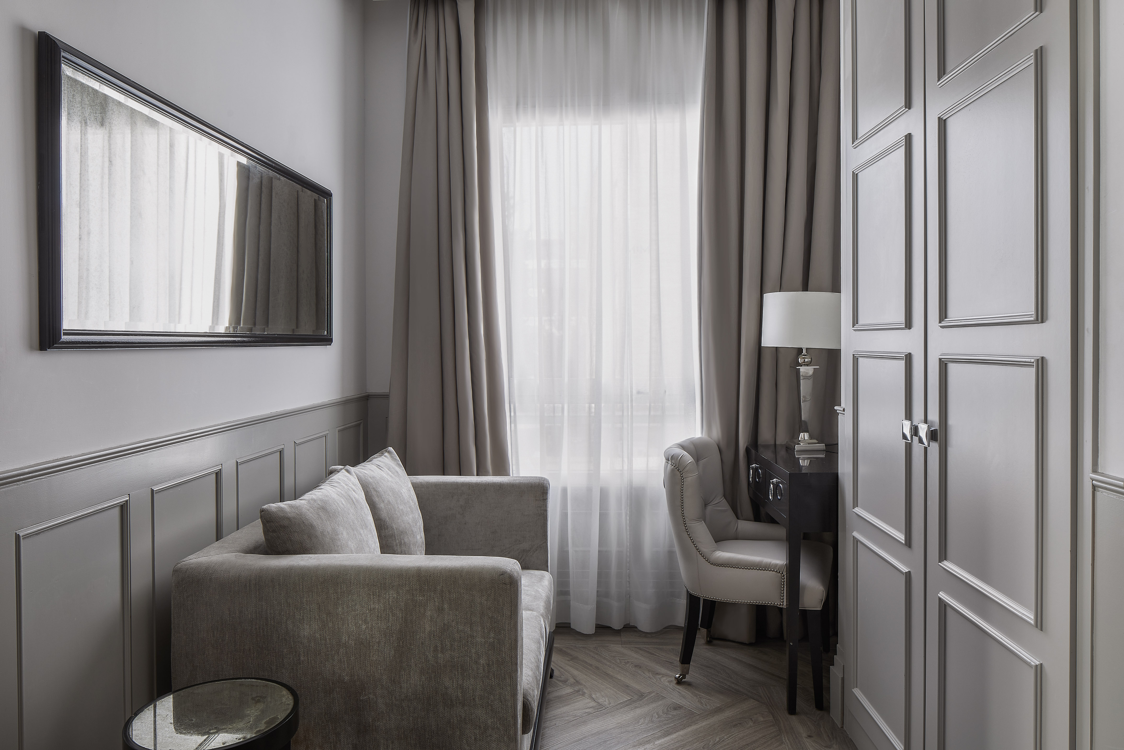 a room with a couch and a mirror