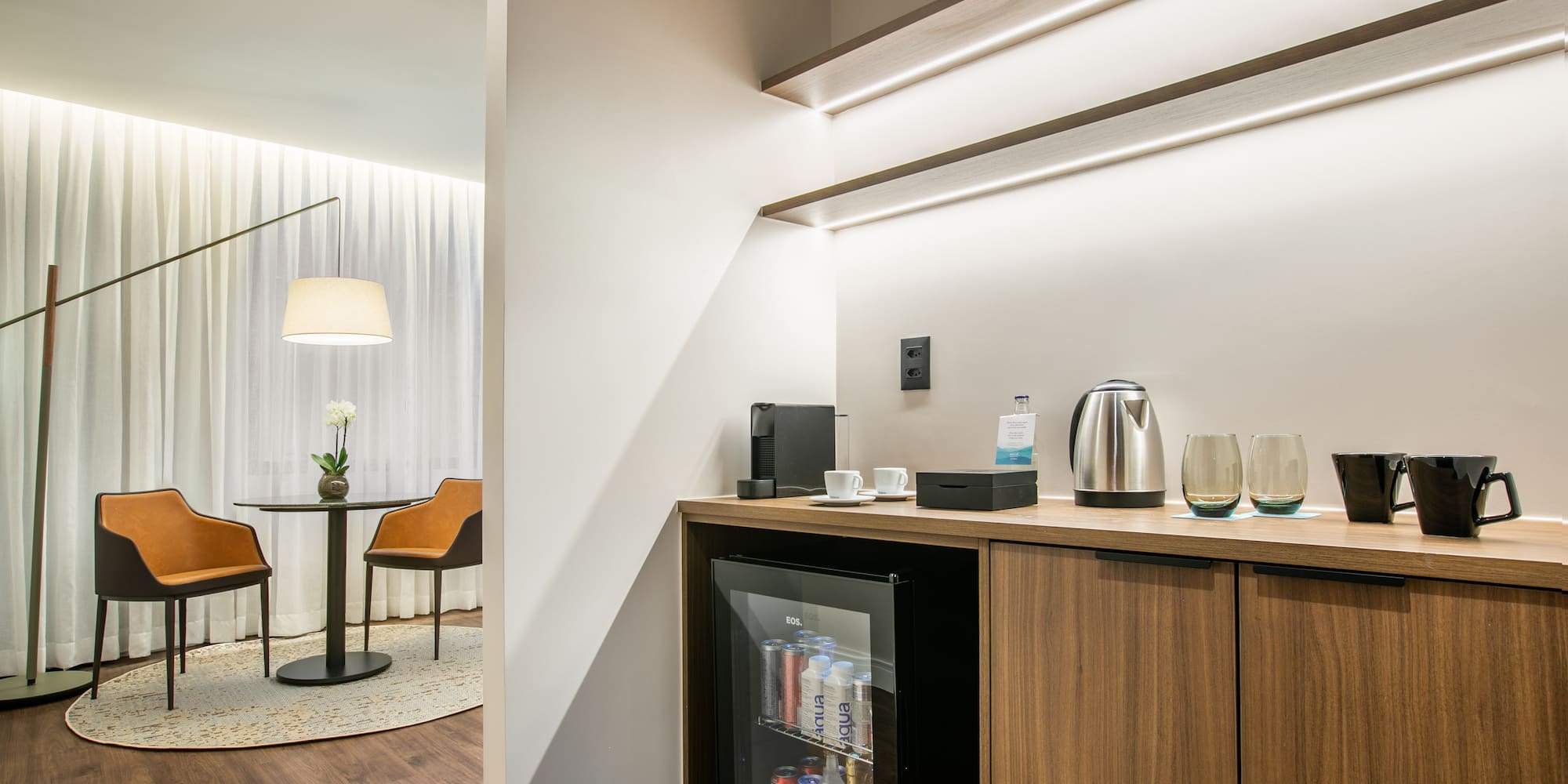 a room with a mini fridge and coffee maker