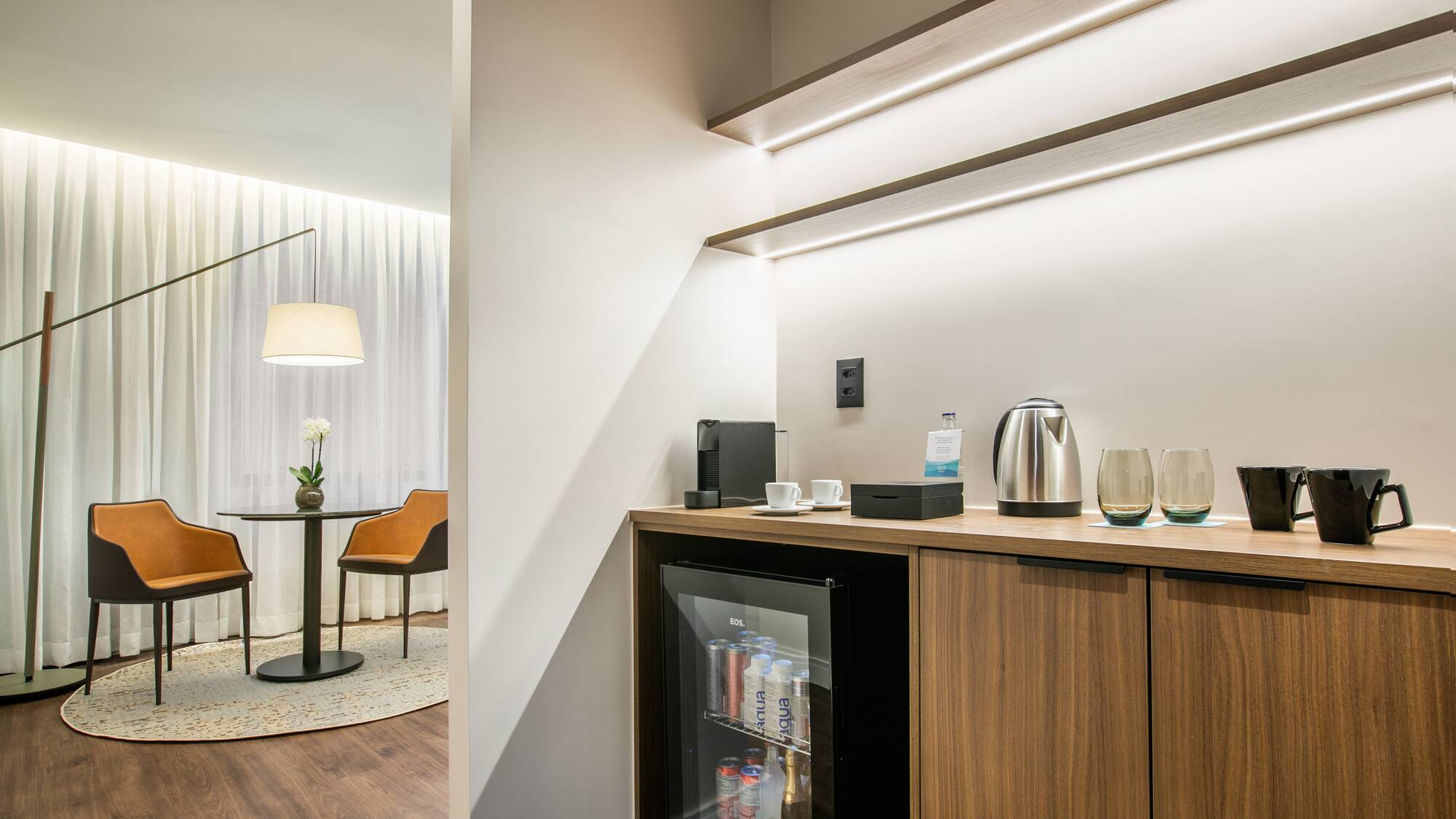 a room with a mini fridge and coffee maker