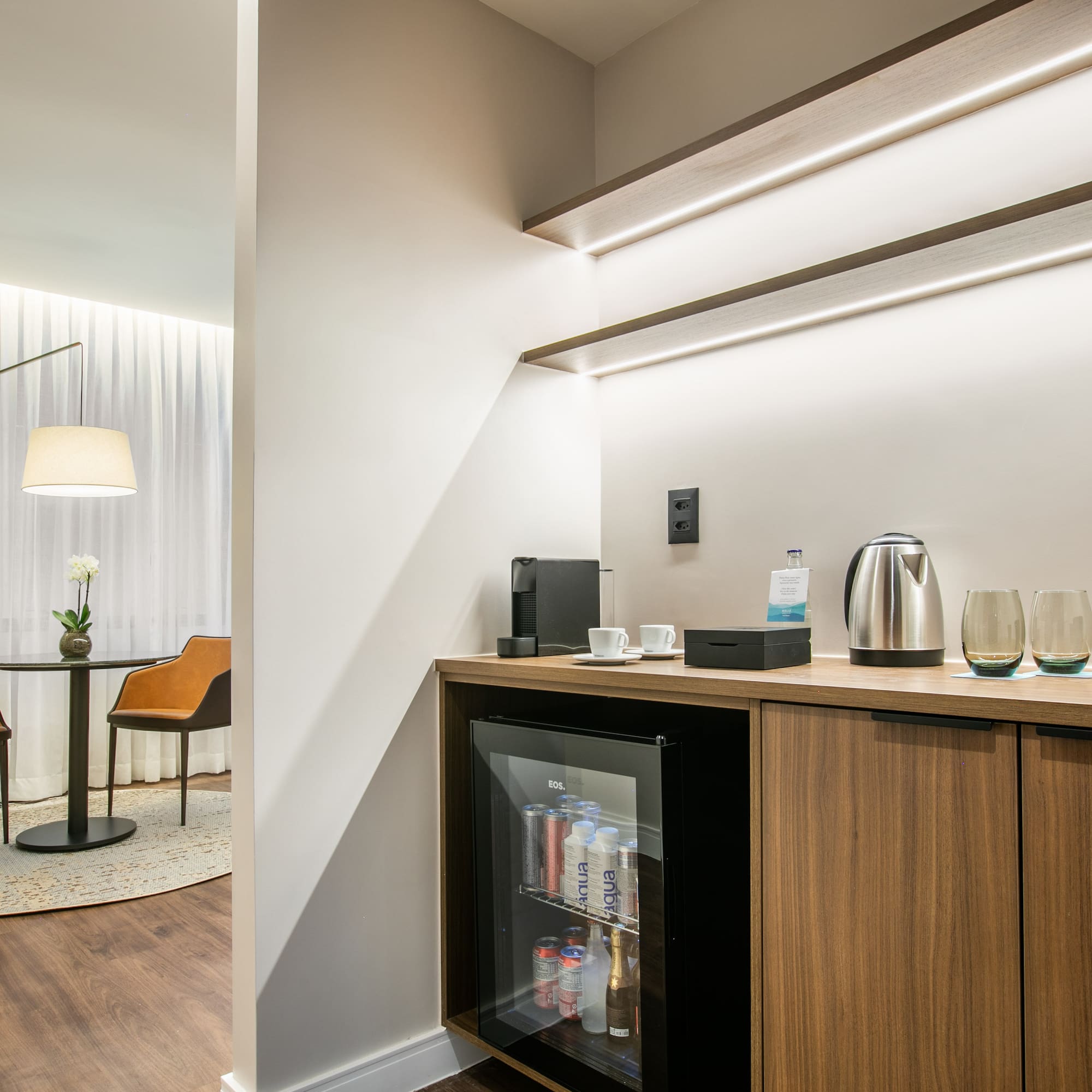a room with a mini fridge and coffee maker